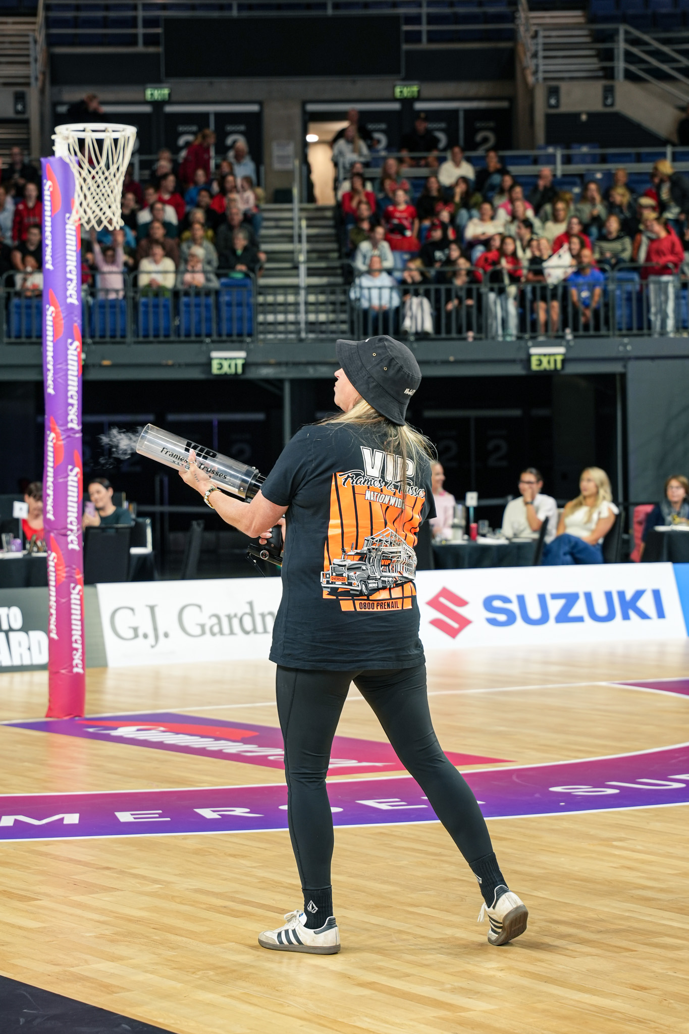 woman shooting tshirt from cannon gun active marketing at netball game nz